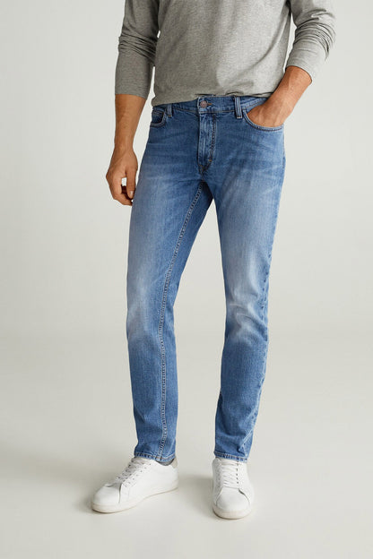 Blue denim jeans with straight legs, belt loops and five-pocket design