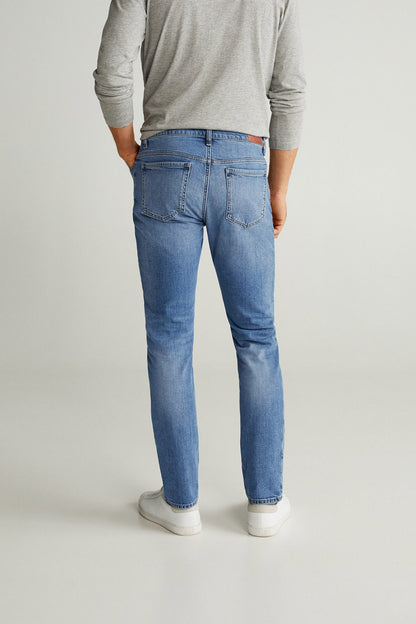 Blue denim jeans back view with belt loops, patch pockets and straight legs