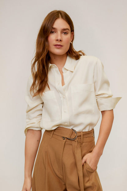 Mango ecru button-up blouse with brown high-waist cropped trousers, side view