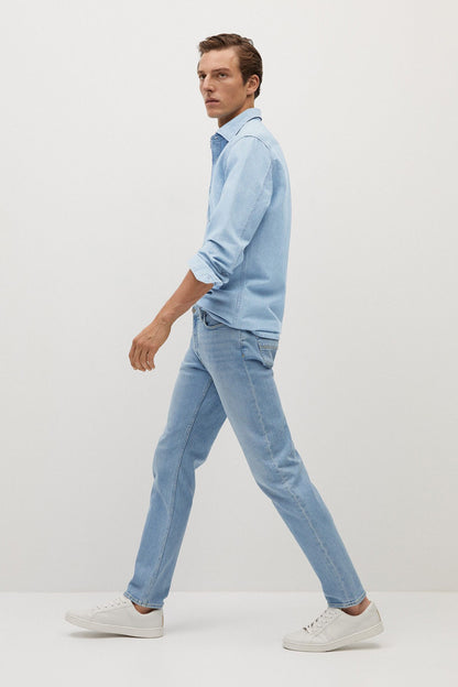 Light blue denim shirt and jeans outfit, long sleeves and straight-leg jeans.