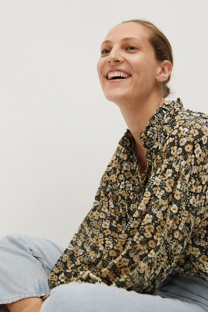 Floral button-up blouse close-up, black with beige tiny flowers and collared neck