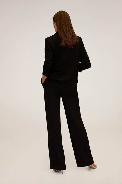 Black suit blazer and wide-leg trousers, back view with cuffed sleeves