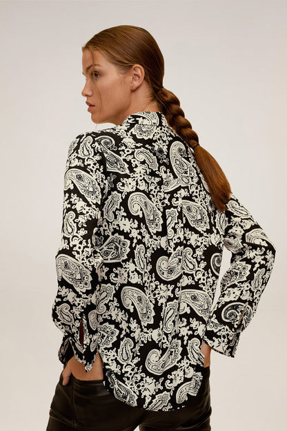 Paisley print button-up blouse in black and white, long sleeves, side view