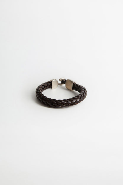 Dark brown braided leather bracelet with silver-toned clasp and hammered metal ends