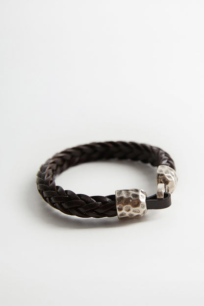 Dark brown braided bracelet with silver-toned hammered bead and clasp detail