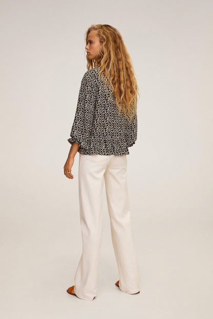 Black-and-white speckle peplum blouse with white wide-leg pants