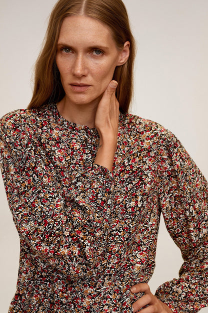 Floral long-sleeve blouse close-up with V-neck and small button placket, multicolor print