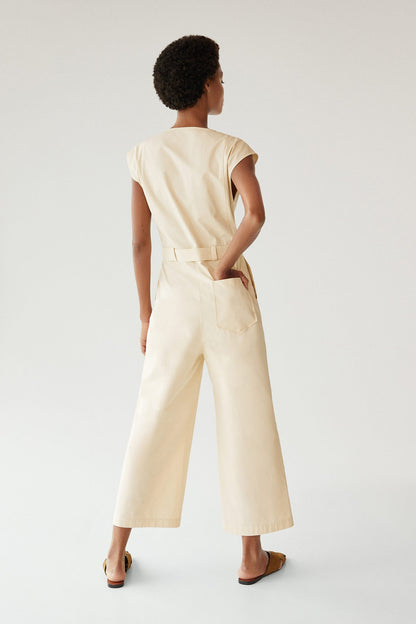 Cream back-view tie-waist jumpsuit with cap sleeves and patch pockets