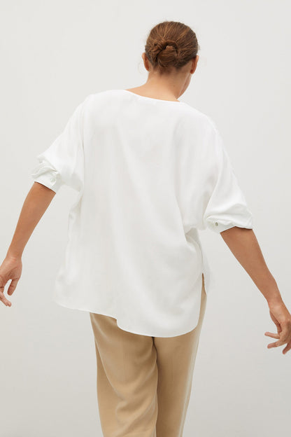 Off-white blouse back view with loose fit and short sleeves