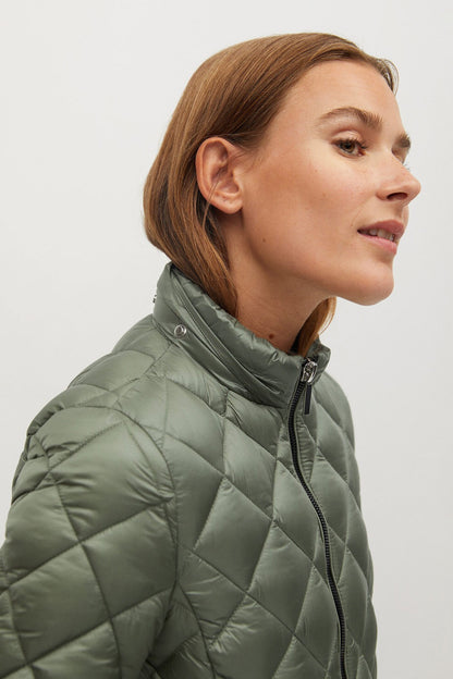 Green quilted puffer jacket close-up with standing collar and front zipper