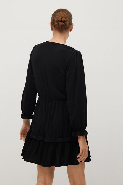 Black V-neck long-sleeve mini dress, back view, gathered waist and tiered skirt