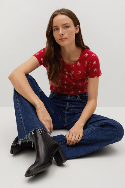 Red short-sleeve graphic T-shirt with logo print, styled with blue jeans