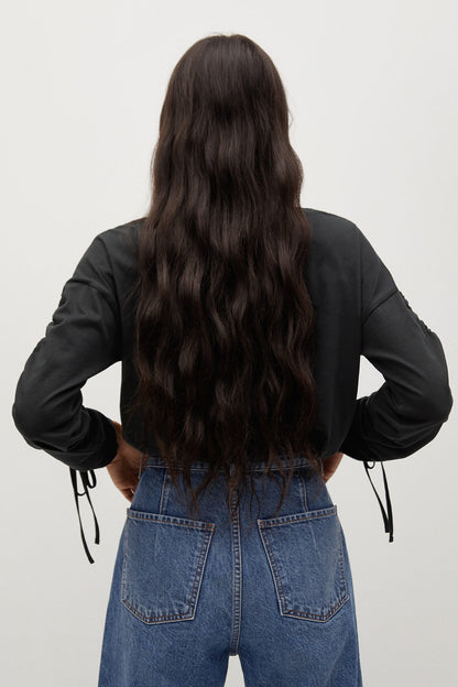 Black long-sleeve top shown from back, ruched cuffs and side drawstrings