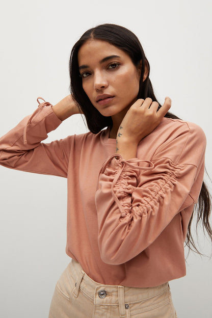 Dusty pink ruched long-sleeve blouse with gathered front and elastic cuffs