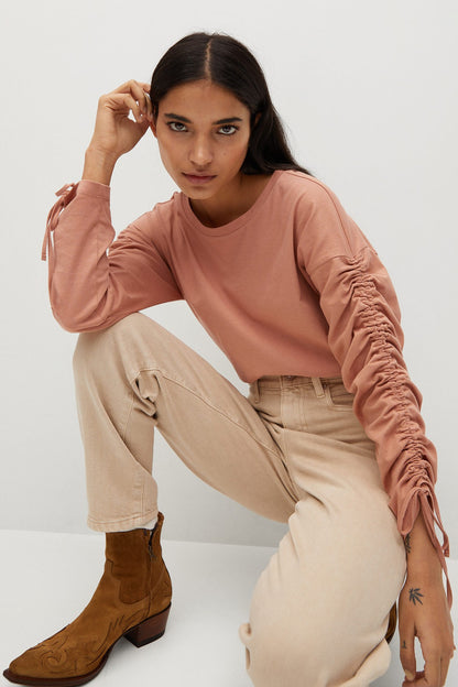 Dusty pink ruched long-sleeve blouse with shoulder gathers and ruffled side