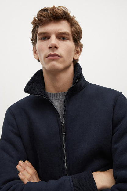 Navy zip-up fleece jacket with dark collar lining and silver zipper