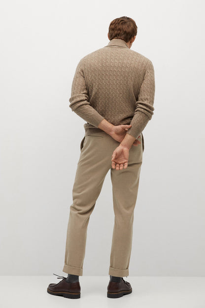 Beige chino-style trousers from the back, tapered legs and cuffed hem