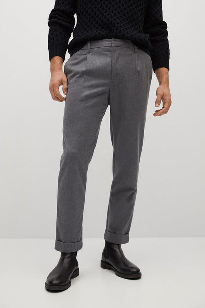 Grey tailored trousers with belt loops, front pleats, and cuffed hems
