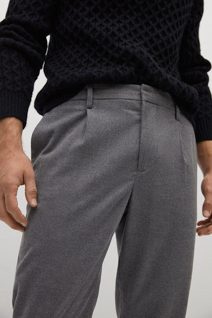Grey trousers close-up: waistband with belt loops and front pleat