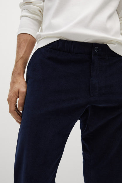 Mango navy trousers close-up: fly button and seam details