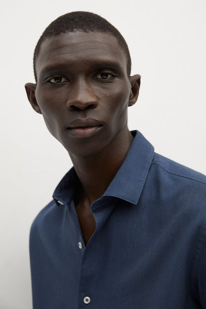 Navy button-up shirt close-up with collar and front buttons