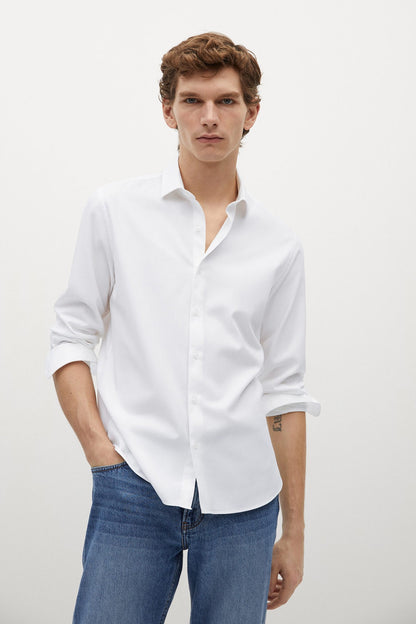 Off-white button-up shirt with long sleeves and open collar