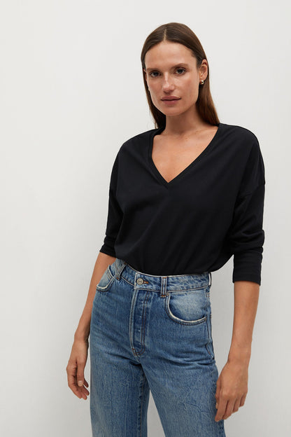 Black long-sleeve V-neck top with cuffed sleeves