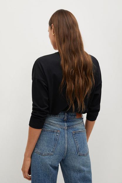 Black long-sleeve V-neck top, back view, cuffed sleeves