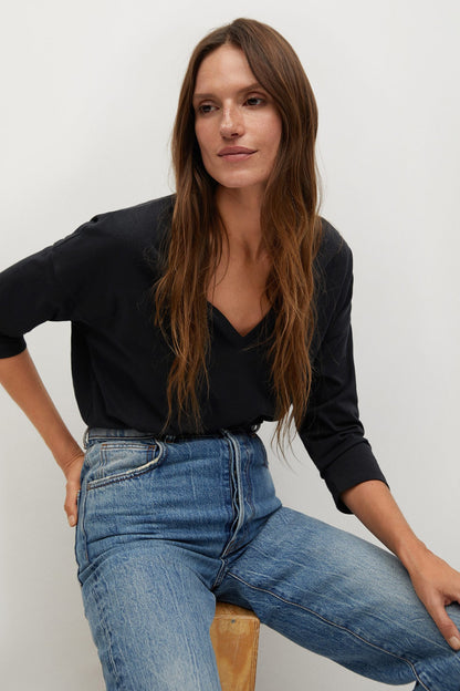 Black long-sleeve V-neck top with cuffed sleeves