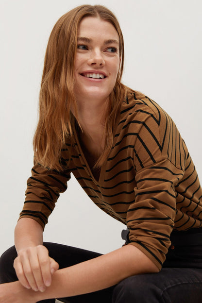 Camel and black striped V-neck long-sleeve top, close-up