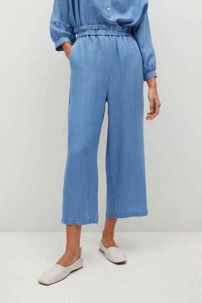 Light blue denim wide-leg pants with elastic waist and cropped length