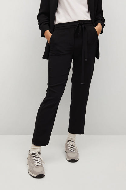 Black tie-waist trousers with tapered legs and cuffed hem