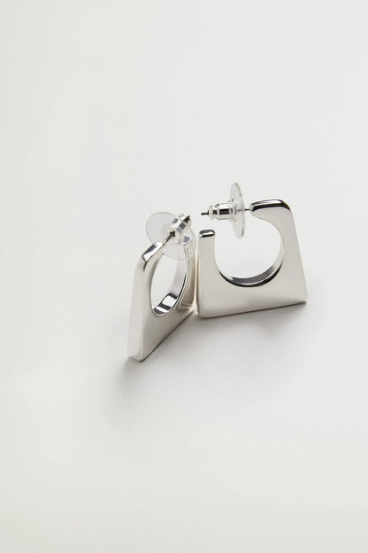Silver hoop earrings with square backplate and hinged latch, side angle