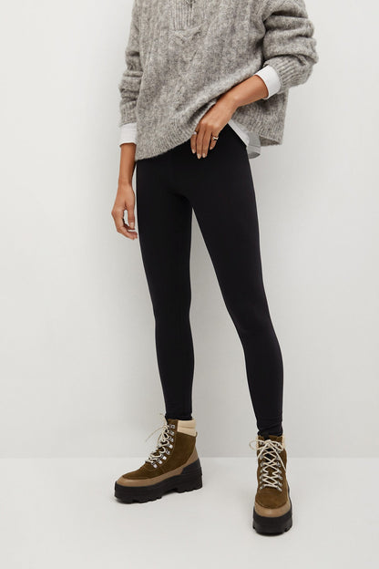 Black slim leggings with gray knit sweater sleeves and cuffs
