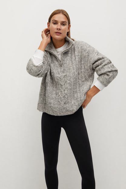 Gray quarter-zip knit sweater and black slim leggings on model