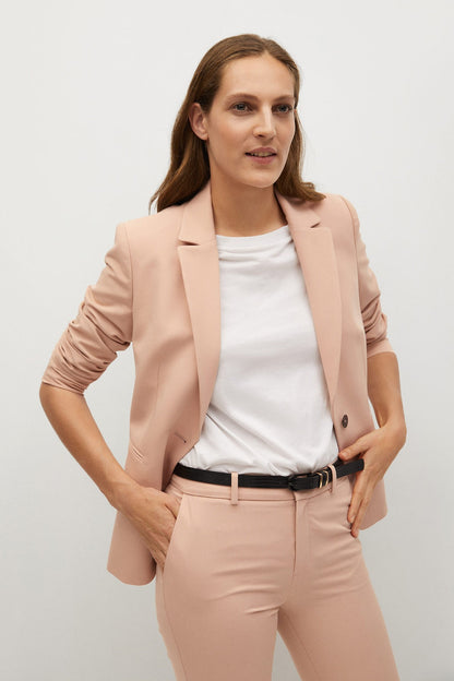 Peach tailored blazer and trousers with belt, notched lapel and front pockets