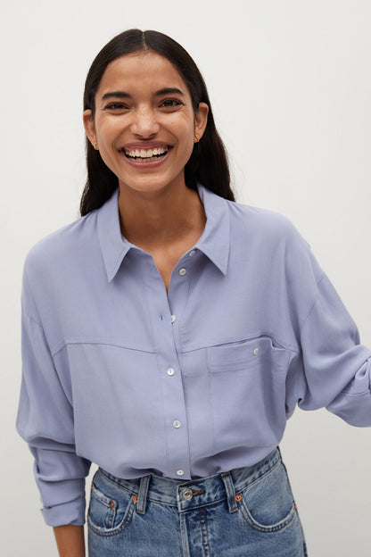 Light blue button-up shirt with pointed collar and chest pocket, long sleeves