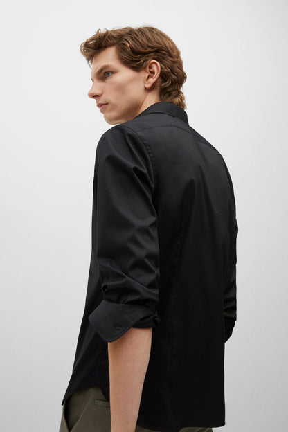 Black long-sleeve button-up shirt, side view with curved hem
