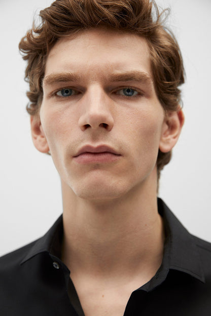 Black shirt collar with button placket, close-up