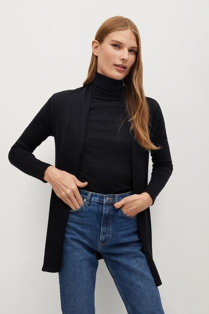 Black long cardigan with open front, worn over black turtleneck
