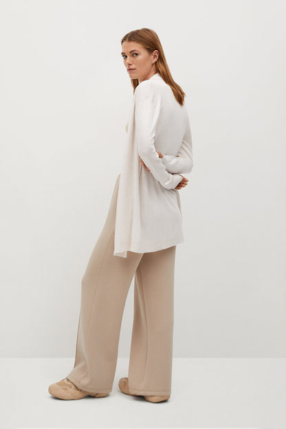 Ecru knit cardigan with long sleeves and draped open front, tie at waist