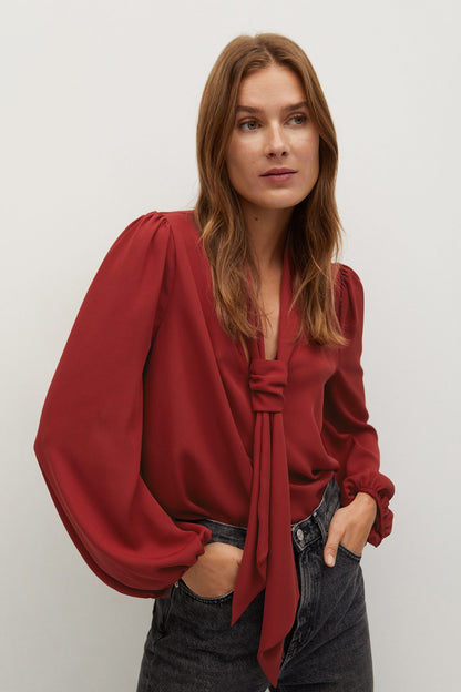Red blouse with tie neckline and long puff sleeves