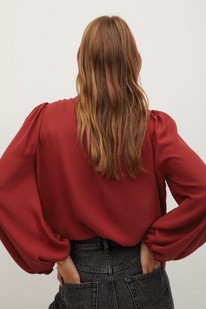 Red blouse with tie neckline and long puff sleeves, back view