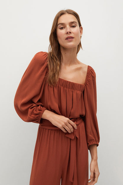 Burnt orange square-neck puff-sleeve jumpsuit, elastic waist and belt ties