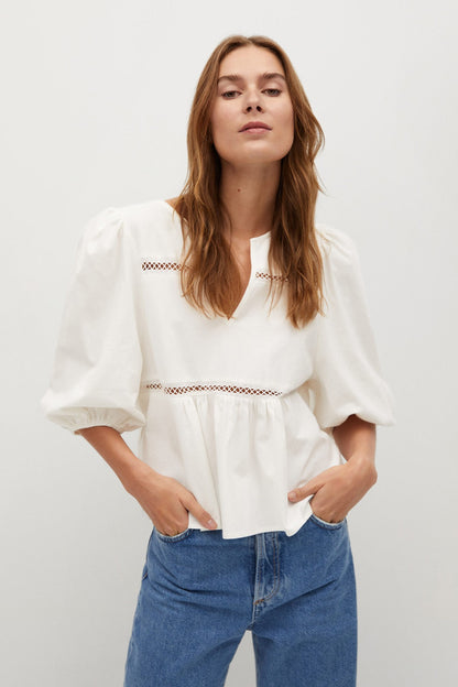 White puff-sleeve blouse with embroidered neckline and gathered waist