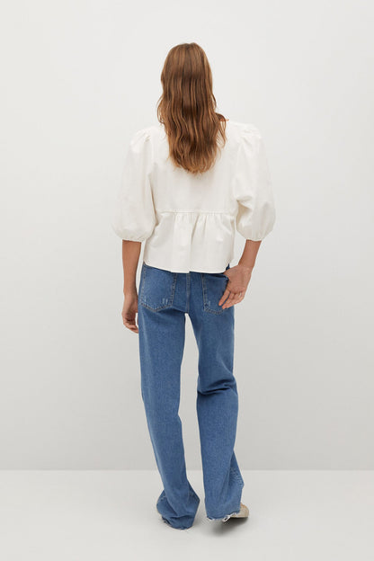 White peplum-style blouse with puff sleeves and back yoke detail