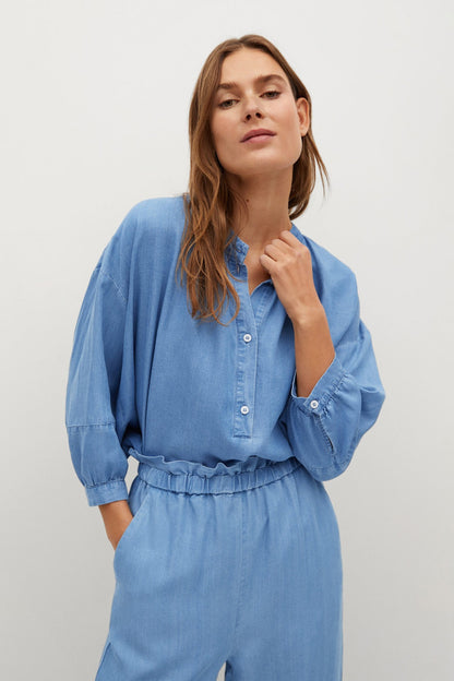 Light blue button-front jumpsuit with long sleeves, elastic waist, cropped wide legs