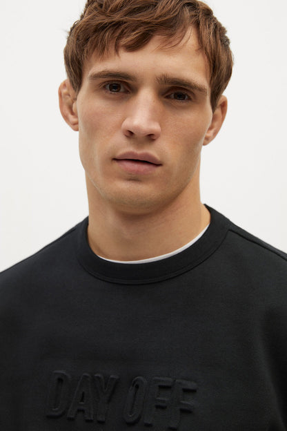 MANGO black crewneck sweatshirt close-up of chest logo