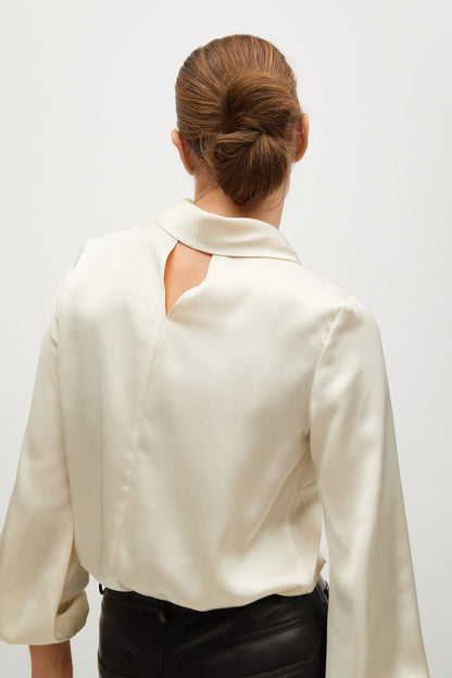 Ecru long-sleeve blouse back view with high collar and small cutout detail