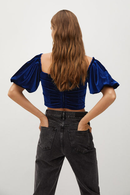 Blue velvet ruched cropped top with puff sleeves, back view